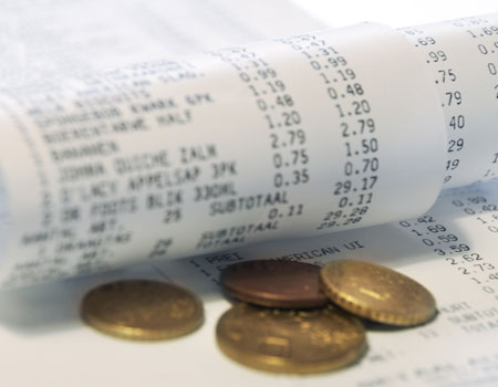 A picture of a shopping receipt and 4 coins